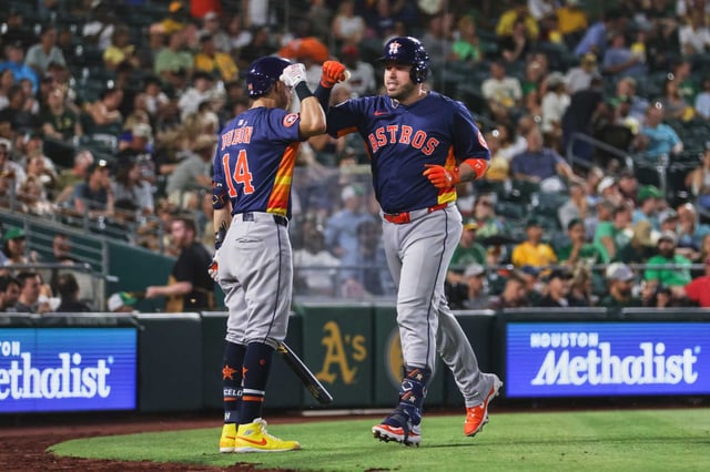 Houston Astros&#39; Victor Caratini, right, celebrates with Mauricio Dubón (14) after hitting a three run home run during the sixth inning of a baseball game against the Athletics Wednesday, June 18, 2025, in West Sacramento, Calif. (AP Photo/Scott Marshall)