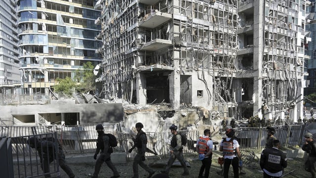 escue workers and military personnel inspect the site of a direct hit from an Iranian missile strike in Ramat Gan, Israel, Thursday, June 19, 2025. 