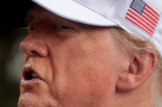 U.S. President Donald Trump talks to reporters as workers install a new flag pole on the South Lawn of the White House on June 18, 2025 in Washington, DC.