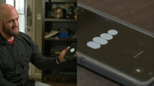 An image featuring a man holding his phone with ChatGPT open.