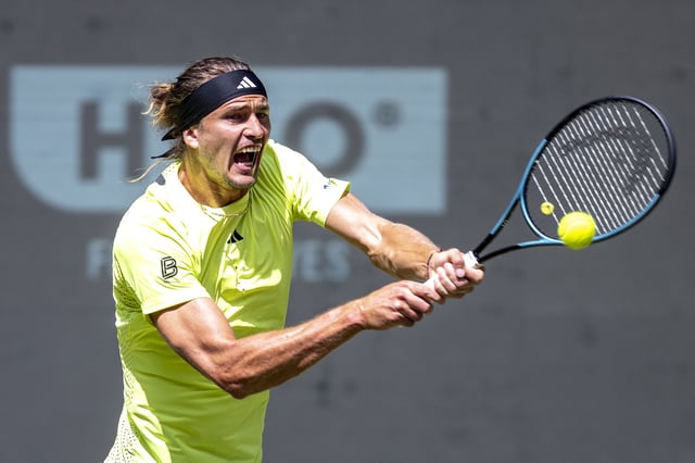 Germany's Alexander Zverev returns the ball to USA's Marcos Giron during the Halle ATP tennis tournament in Halle, Germany, Wednesday, June 18, 2025. (David Inderlied/dpa via AP)