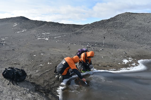 Researchers Ian Hawes of the University of Waikato and Marc Schallenberg of the University of Otago measure the physicochemical conditions of a meltwater pond.