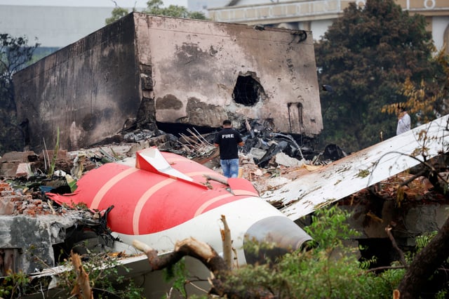 A fire officer stands next to the crashed Air India Boeing 787-8 Dreamliner aircraft, in Ahmedabad, India, June 13, 2025. REUTERS/Adnan Abidi/File Photo