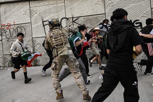 US Customs and Border Protection agents disperse protester in front of the Federal Building during ongoing demonstrations in response to federal immigration operations in downtown Los Angeles on June 12, 2025.