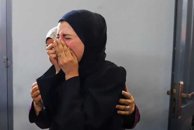 A woman reacts as Palestinians, wounded in an Israeli strike, according to the Gaza Health Ministry, receive treatment at Al-Shifa hospital in Gaza City, June 19, 2025. REUTERS/Ebrahim Hajjaj