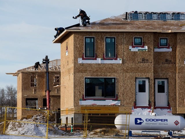 Construction crews work on homes in west Edmonton in 2024. 