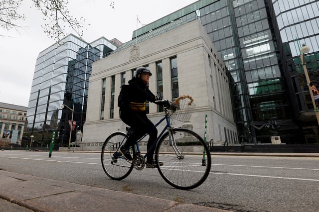 A cyclist rides past the Bank of Canada building in Ottawa, Ontario, Canada May 8, 2025. REUTERS/Blair Gable/File Photo