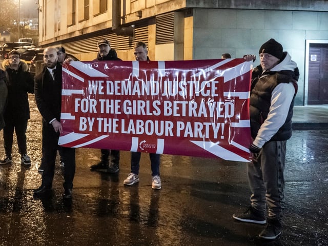 OLDHAM, ENGLAND - JANUARY 20: Nick Tenconi, Interim Leader of the UK Independence Party (UKIP) and Chief Operating Officer of Turning Point UK (centre) poses with banners during a protest calling for justice for victims of sexual abuse and grooming gangs, outside the council offices at City Centre on January 20, 2025 in Oldham, England. Some victims of so-called grooming gangs are demanding a new investigation into historical child sex abuse cases here. The government recently rejected such a request, sparking criticism from political opponents and even US businessman Elon Musk, although Oldham council opted to set up its own investigation. (Photo by Anthony Devlin/Getty Images)