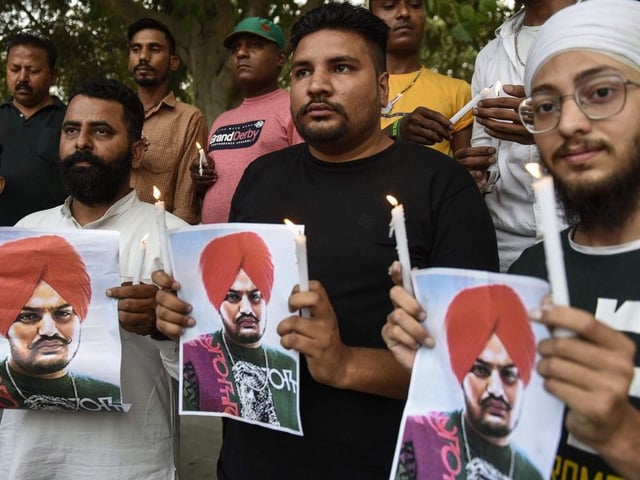 Youth pay tribute to the late Punjabi singer Sidhu Moose Wala who was shot dead on May 29 in Mansa district in India's Punjab state, during a candlelight vigil in Amritsar on May 30, 2022.