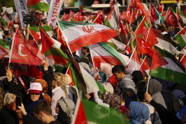 People wave Palestinian, Turkish and Iranian flags during a protest in Istanbul, Turkey, Sunday, June 15, 2025.