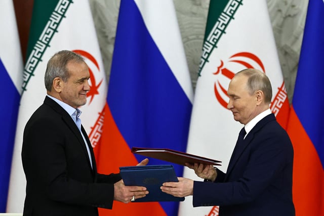 Russian President Vladimir Putin and Iranian President Masoud Pezeshkian sign a strategic partnership treaty at the Kremlin in Moscow on January 17, 2025.