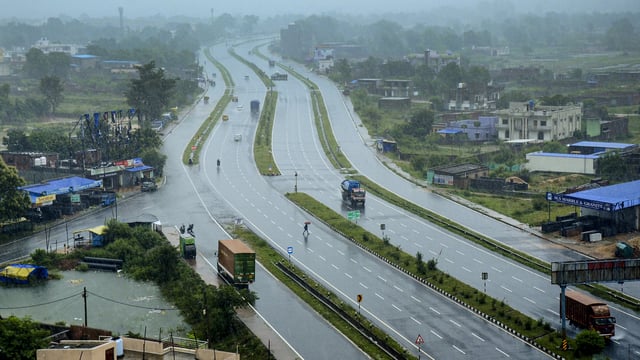 Vehicles ply on ring road during heavy rainfall, in Khunti district, Jharkhand, Thursday, June 19, 2025.