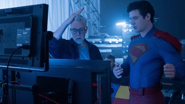 James Gunn standing at a monitor on the Superman set.