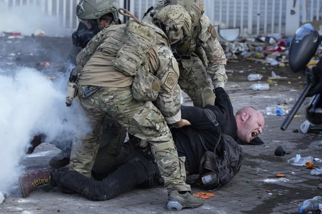 U.S. Customs and Border Protection agents detain a man outside the U.S. Immigration and Customs building during a protest Saturday, June 14, 2025, in Portland, Ore.