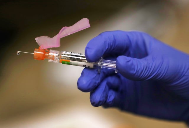KEY BISCAYNE, FLORIDA - SEPTEMBER 03: Enbal Sabag, a Nurse Practitioner, prepares a flu vaccination for a patient at the CVS Pharmacy and MinuteClinic on September 03, 2020 in Key Biscayne, Florida. Flu shots are available at the nearly 10,000 CVS pharmacies and approximately 100 MinuteClinic locations across the country. Heath experts say getting the flu shot this year is important because the dangers of having COVID-19 and the flu simultaneously are still unknown. (Photo by Joe Raedle/Getty Images)