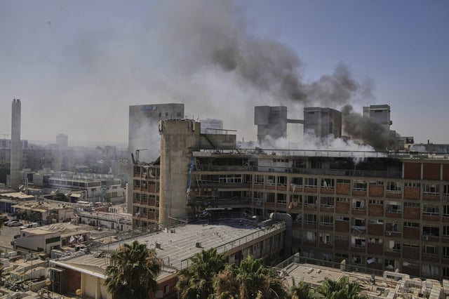Smokes raises from a building of the Soroka hospital complex after it was hit by a missile fired from Iran in Beersheba, Israel, Thursday, June 19, 2025. (AP Photo/Leo Correa)