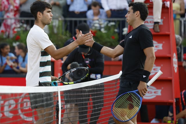 Tennis - Queen's Club Championships - Queen's Club, London, Britain - June 19, 2025 Spain's Carlos Alcaraz and Spain's Jaume Munar shake hands after their round of 16 match Action Images via Reuters/Peter Cziborra