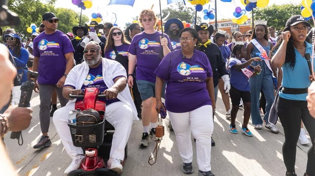 The walk participants led by Dione Sims, the granddaughter of Opal Lee, begin to walk on their route for the Opal Lee Walk for Freedom at Farrington Field in Fort Worth on Thursday, June 19, 2025.