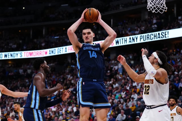 Apr 11, 2025; Denver, Colorado, USA; Memphis Grizzlies center Zach Edey (14) grabs a rebound over Denver Nuggets forward Aaron Gordon (32) in the second half at Ball Arena. Mandatory Credit: Ron Chenoy-Imagn Images/File Photo
