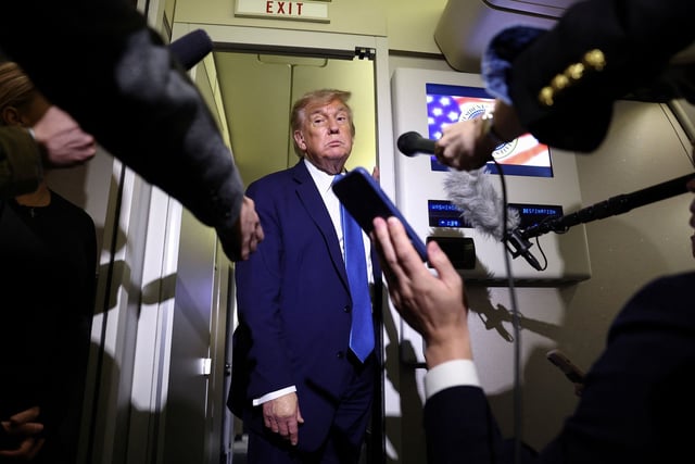 President Donald Trump speaks to reporters aboard Air Force One after departing early from the the G7 summit in Canada to return to Washington, DC, on June 17.