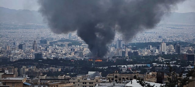 TEHRAN, IRAN - JUNE 16: Smoke rises after a reported Israeli strike on a building used by Islamic Republic of Iran News Network, part of Iran&#39;s state TV broadcaster, on June 16, 2025 in Tehran, Iran. Over recent days, Iran has been hit by a series of Israeli airstrikes targeting military and nuclear sites, as well as top military officials, prompting Iran to launch a counterattack. (Photo by Stringer/Getty Images)
