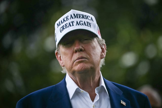 US President Donald Trump speaks to the press as workers install a large flag pole on the South Lawn of the White House in Washington, DC on June 18, 2025.