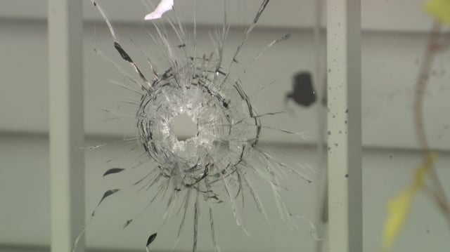 Bullet holes can be seen in the windows of the Surrey trucking business.