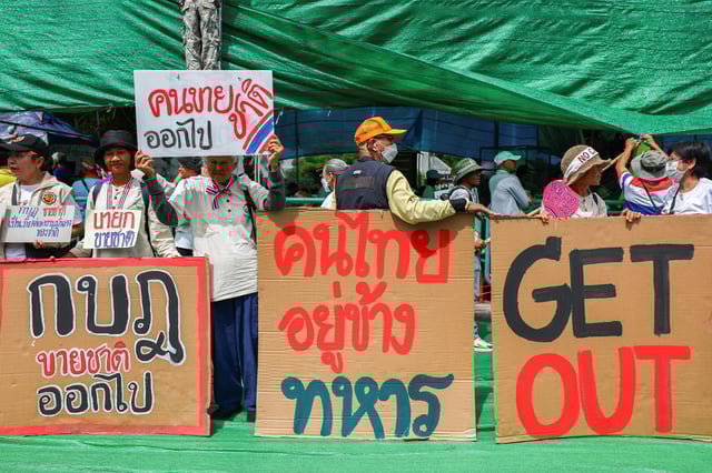 Royalist activists hold signs as they take part in an anti-government protest, following a leak on Wednesday of a phone call between Thailand's Prime Minister Paetongtarn Shinawatra and Cambodia's Hun Sen, the influential former premier of Cambodia, amid a border dispute between the two countries, near the Government House, in Bangkok, Thailand, June 19, 2025. REUTERS/Chalinee Thirasupa