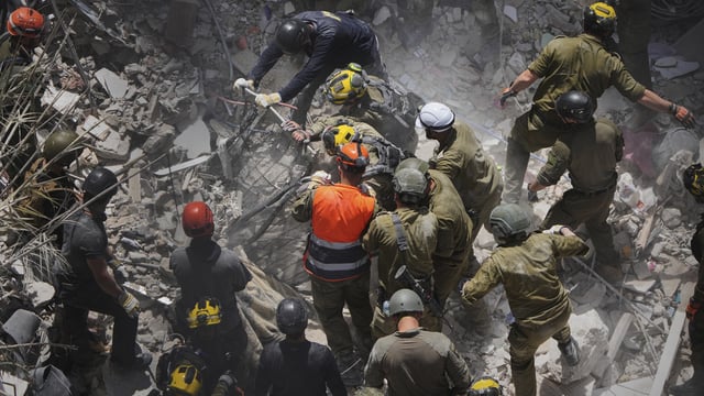 Israeli soldiers search for survivors amid the rubble of residential buildings destroyed by an Iranian missile strike in Bat Yam, central Israel, June 15, 2025.