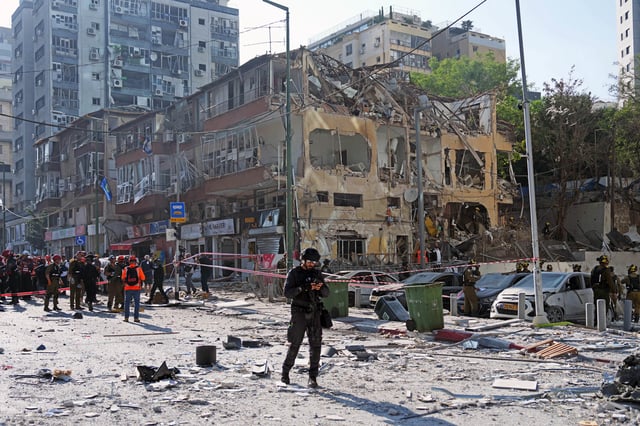 Emergency workers respond to the site of a reported Iranian missile strike on June 19, 2025 in Ramat Gan, Israel.