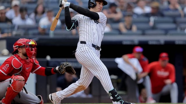 Jun 19, 2025; Bronx, New York, USA; New York Yankees left fielder Cody Bellinger (35) follows through on an RBI single against the Los Angeles Angels during the seventh inning at Yankee Stadium. Mandatory Credit: Brad Penner-Imagn Images