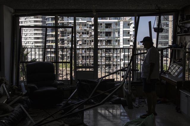 A man inspects a damaged house, a day after an Iranian missile struck an area in Ramat Gan in central Israel near Tel Aviv, on June 20, 2025.