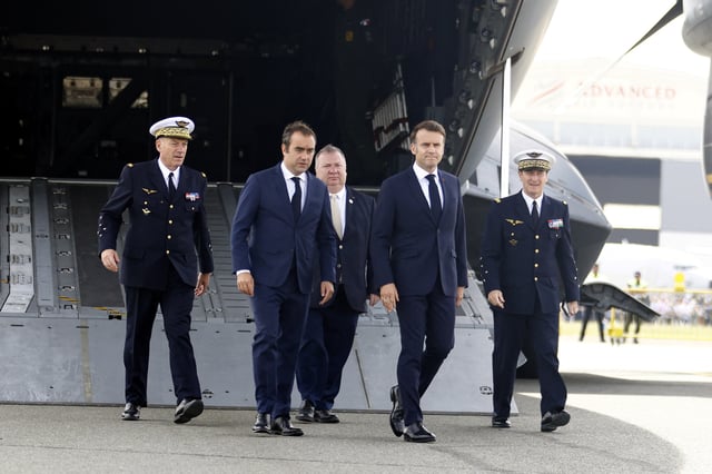 French President Emmanuel Macron walks with French Minister of Armed Forces Sebastien Lecornu during a visit at the 55th edition of the International Paris Air Show at the Paris-Le Bourget Airport, in Le Bourget, near Paris, France, June 20, 2025. MOHAMMED BADRA/Pool via REUTERS