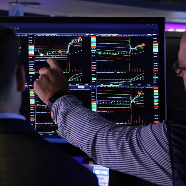 Traders work on the floor at the New York Stock Exchange (NYSE) in New York City, U.S., June 18, 2025.