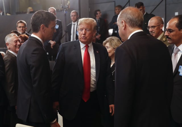 FILE- President Donald Trump, center, stops to talk with Spanish Prime Minister Pedro Sanchez, left, and Turkey's President Recep Tayyip Erdogan, right, as they attend a meeting of the North Atlantic Council during a summit of heads of state and government at NATO headquarters in Brussels on July 11, 2018. 