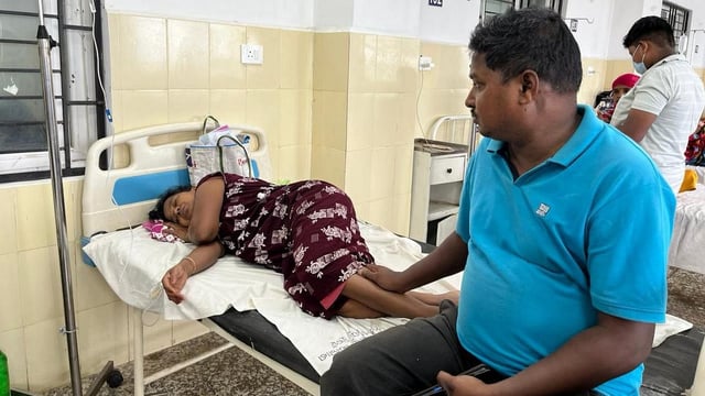 Mamta Barik lies on a hospital bed in Jajpur. Her brother, who is attending to her, said she had eaten too much chicken and added, “We don’t know what cholera is” | Photo: Nootan Sharma | ThePrint