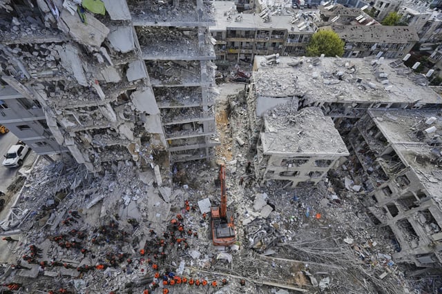 Israeli soldiers search through the rubble of residential buildings destroyed by an Iranian missile strike in Bat Yam, central Israel, on Sunday, June 15, 2025.