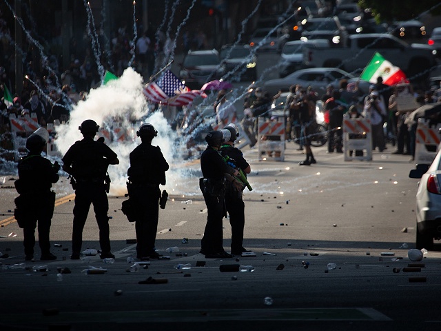 08 June 2025, US, Los Angeles: A picture made available on June 11, 2025 shows demonstrators setting off fireworks during a protest against immigration raids conducted by ICE and Federal police in Los Angeles. Photo: Zin Chiang/dpa (Photo by Zin Chiang/picture alliance via Getty Images)
