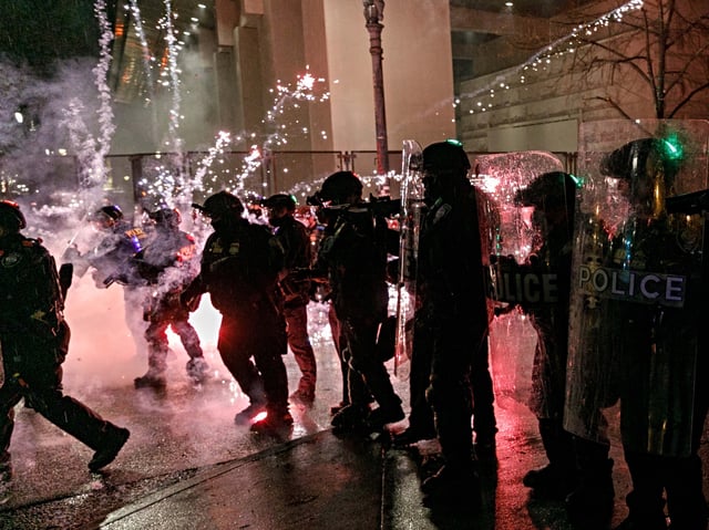 PORTLAND, OREGON, USA - DECEMBER 31: Protesters throw fireworks to police officers during a protest against police brutality near the Federal Courthouse in Portland, Oregon, United States on December 31, 2020. (Photo by John Rudoff/Anadolu Agency via Getty Images)