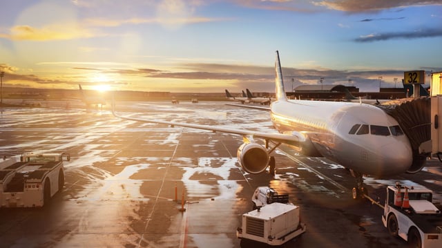 Airplane at terminal gate in international airport stock photo
