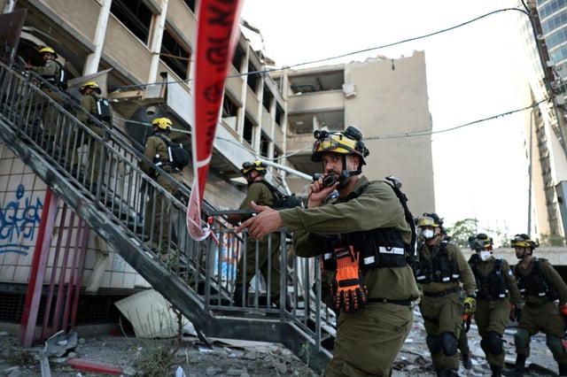 Israeli first responders at the scene of a reported Iranian strike in Haifa