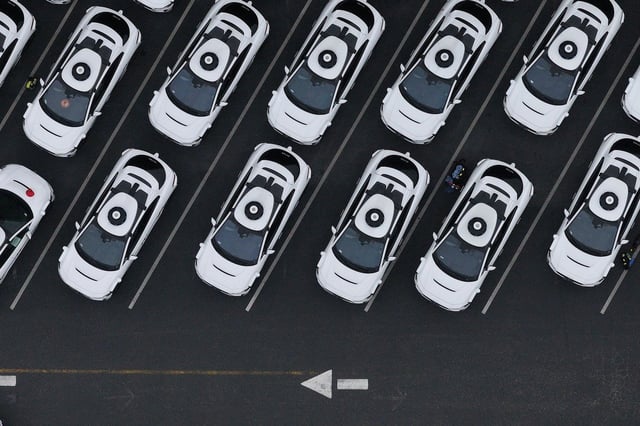 SAN FRANCISCO, CALIFORNIA - JUNE 10: In an aerial view, Waymo cars are seen parked at a Waymo facility on June 10, 2025 in San Francisco, California. Robo-taxi company Waymo has limited service in San Francisco after several Waymo cars were set on fire and destroyed during the anti-immigration protests in Los Angeles over the past week. (Photo by Justin Sullivan/Getty Images)