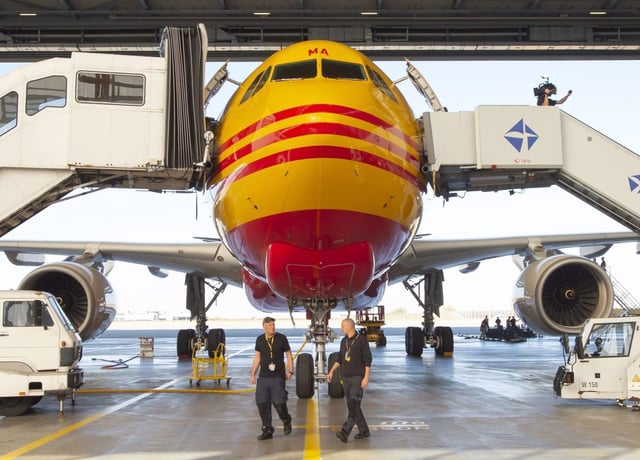A DHL Express airplane stands in the hangar during the official launching ceremony of the Airbus A330-200 cargo airplane by the European Air Transport Leipzig GmbH (EAT) at the DHL's European air freight hub in Schkeuditz near Leipzig, Germany, Friday, Oct. 12, 2018. (AP Photo/Jens Meyer)