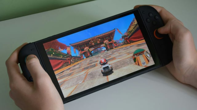 Nintendo Switch 2 handheld gameplay – Mario Kart World with Shy Guy in free roam mode on Cheep Cheep Falls course