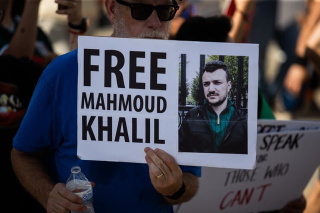 Protesters gather at Ervan Chew Park in Houston, Texas, on June 8 for a demonstration against Trump immigration policies and mass deportations. A protester holds a sign that reads, "Free Mahmoud Khalil."