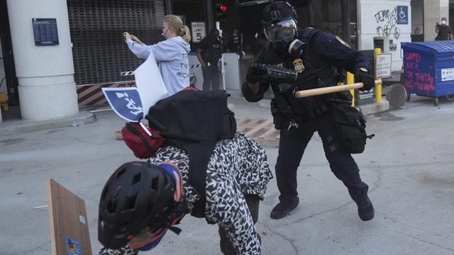 A protester attempts to evade a Department of Homeland Security officer after federal immigration authorities conducted an operation on Friday, June 6, 2025, in Los Angeles. (AP Photo/Jae C. Hong)