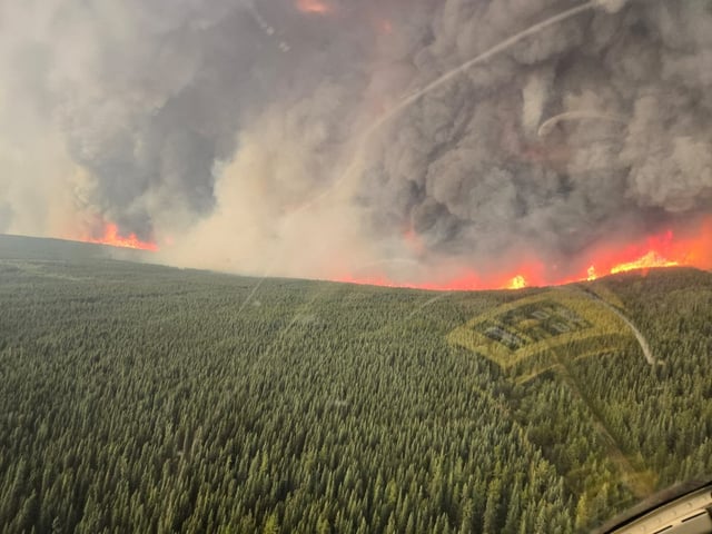 The Pocket Knife Creek wildfire south of Fort Nelson, B.C., seen in this handout photo on Wednesday, June 10, 2025, is now classified as "being held" and is not expected to grow outside its current perimeter. THE CANADIAN PRESS/Handout — BC Wildfire Service (Mandatory Credit)