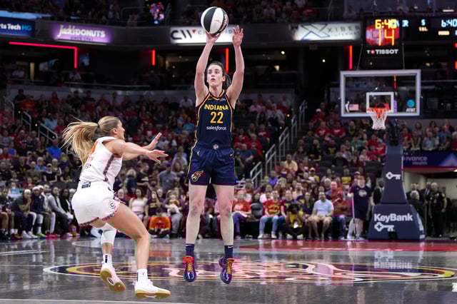 Caitlin Clark #22 of the Indiana Fever attempts a shot while being guarded by Jacy Sheldon #4 of the Connecticut Sun in the first quarter at Gainbridge Fieldhouse on June 17, 2025 in Indianapolis, Indiana.