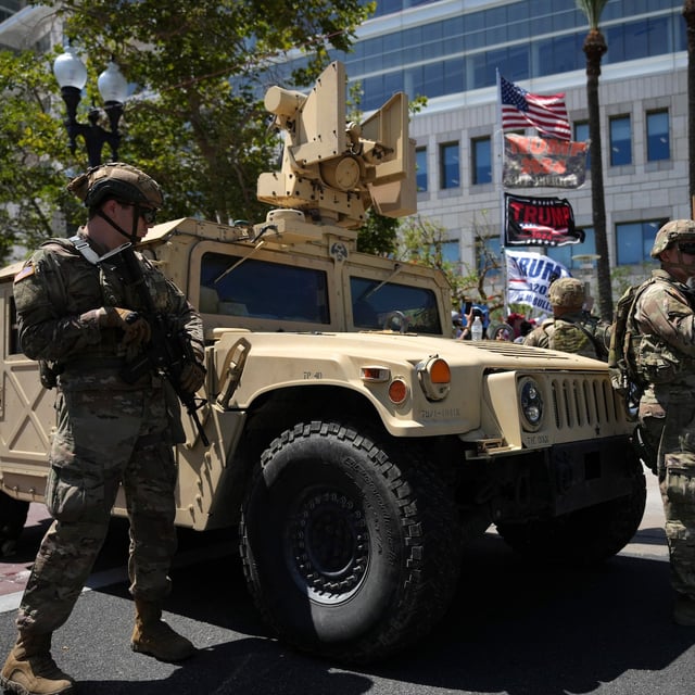 California National Guard stand guard along a street near protesters and Trump supporters in Santa Ana, Calif. on Tuesday, June 10, 2025. (AP Photo Jae C. Hong)