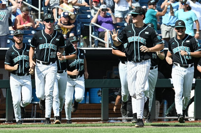 Jun 18, 2025; Omaha, Neb, USA;  The Coastal Carolina Chanticleers bench runs on the field after the win against the Louisville Cardinals at Charles Schwab Field. Mandatory Credit: Steven Branscombe-Imagn Images